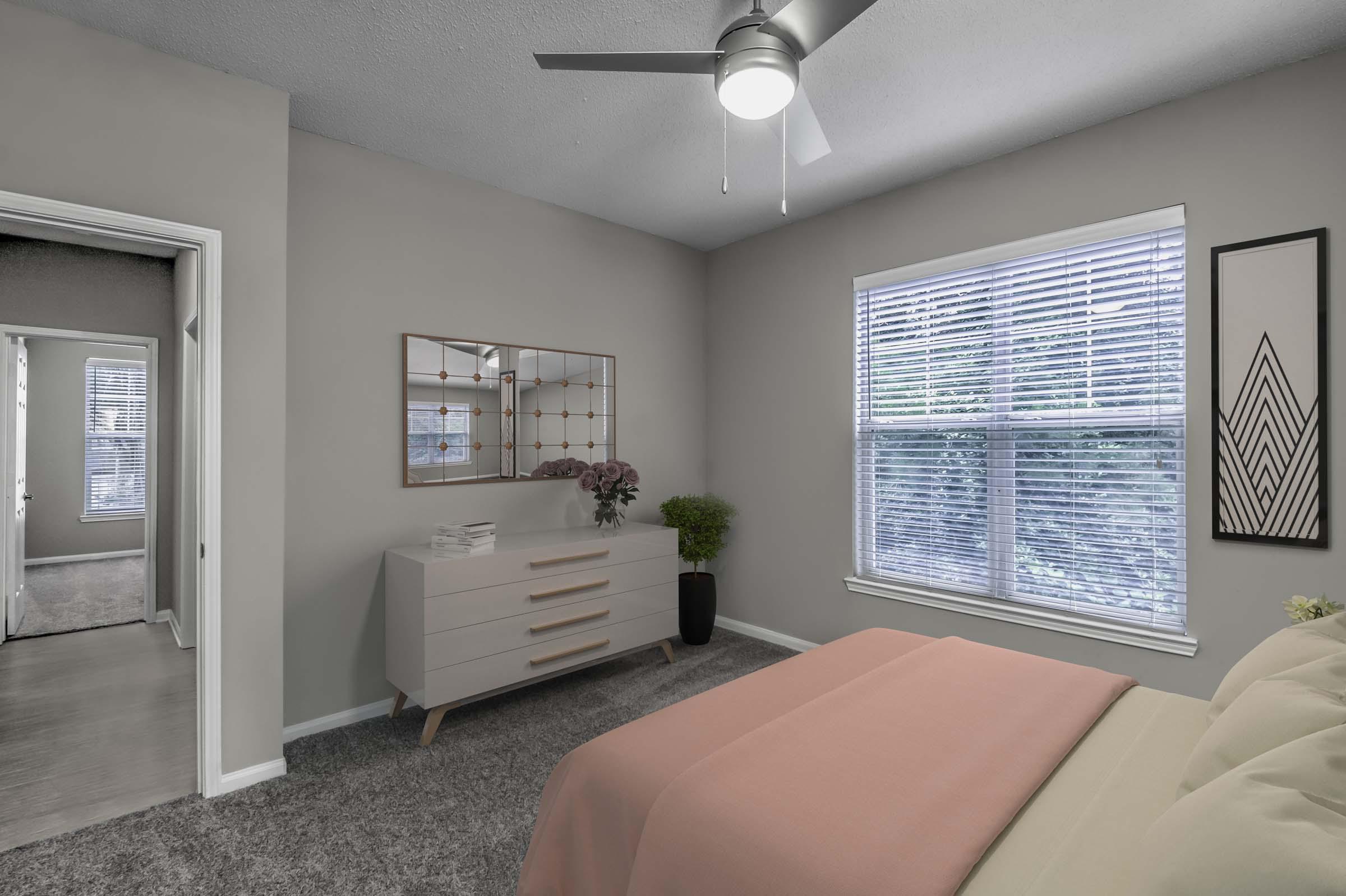 Bedroom with ceiling fan and carpet flooring Camden Deerfield Apartments Alpharetta (770)872-6592