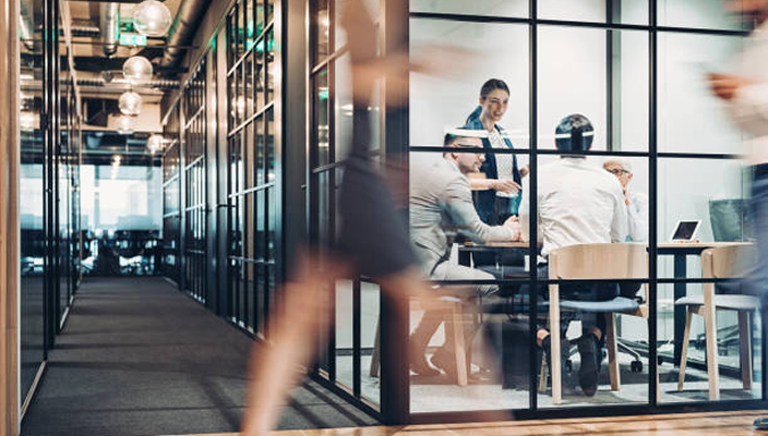 Advisors with clients in an office setting.