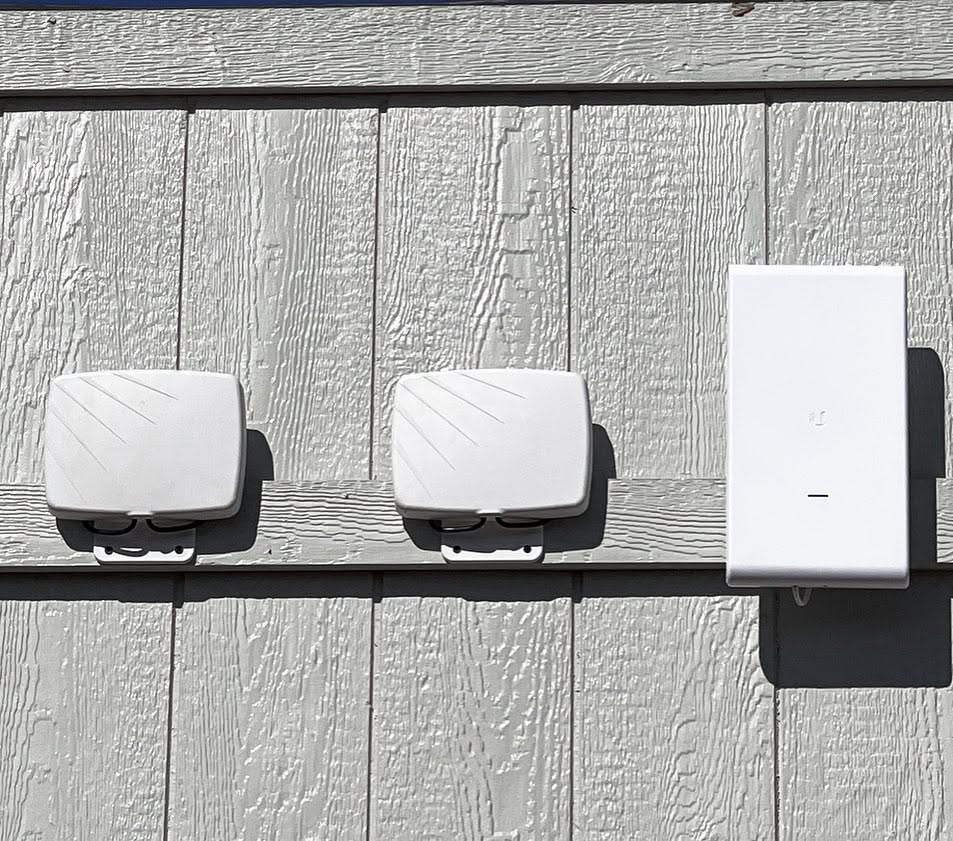 Commercial outdoor Wi-Fi access points mounted on a building for reliable wireless network connectivity