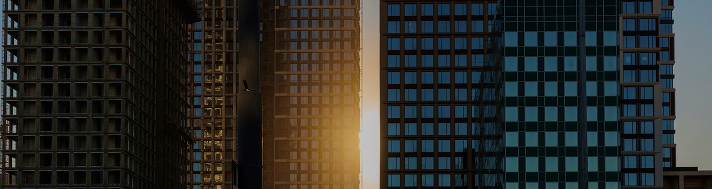 A bottom-up view of a spiral staircase and chandelier.