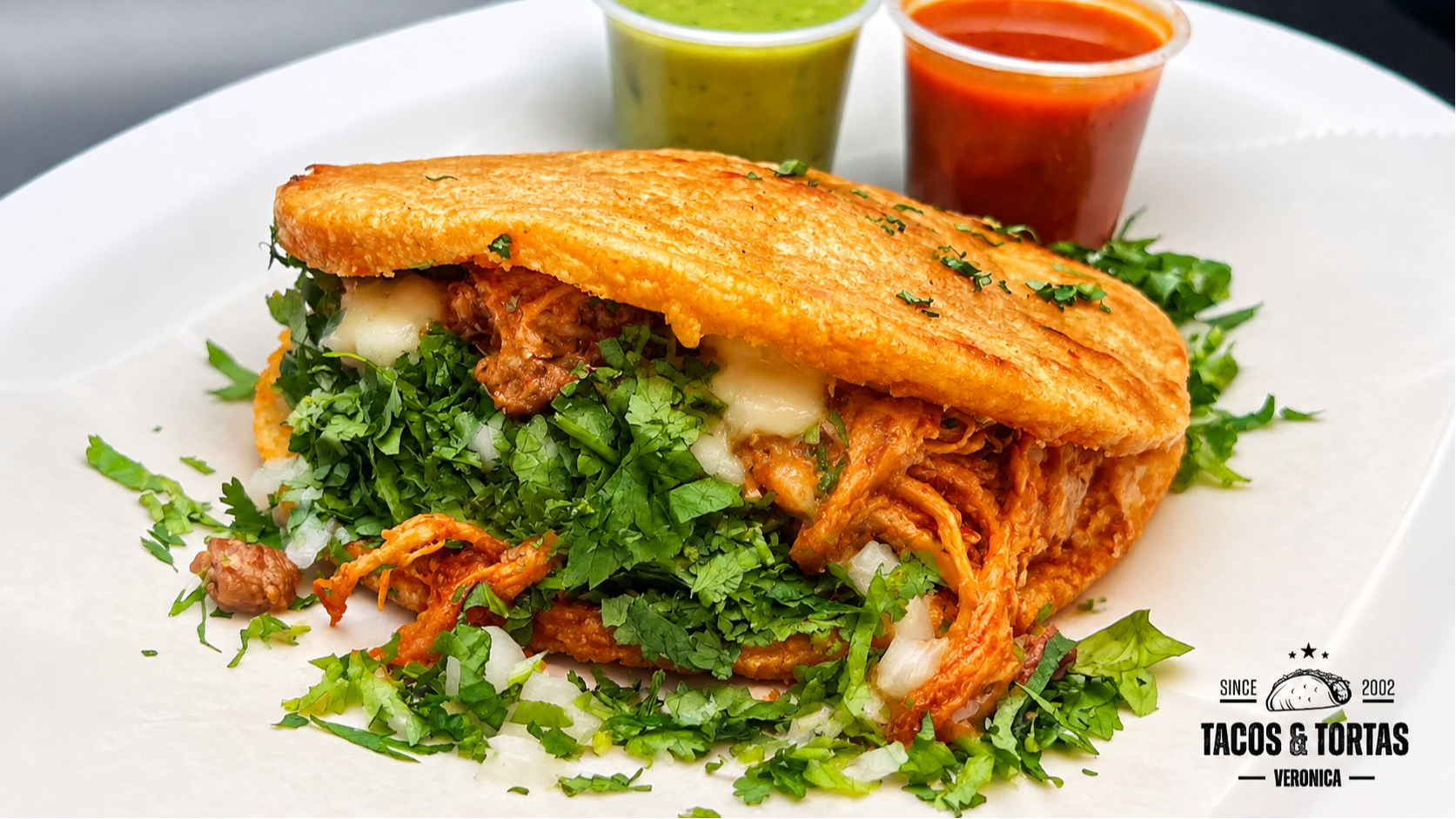 Traditional Mexican dish that consists of a thick, round, and flattened corn cake or tortilla that i 