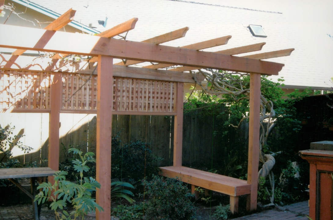 Custom wood pergola and fence structure designed to enhance an outdoor living space.