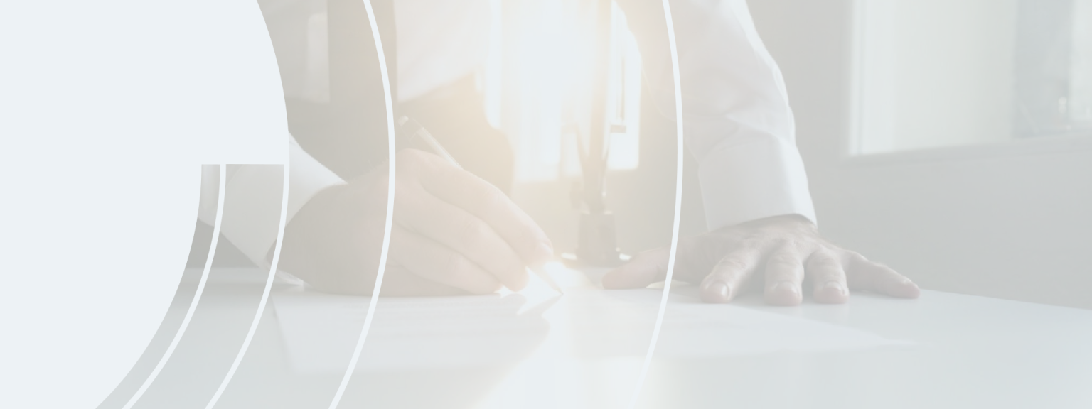 Close up of a wealth professional editing a document with the setting sun shining through the window.