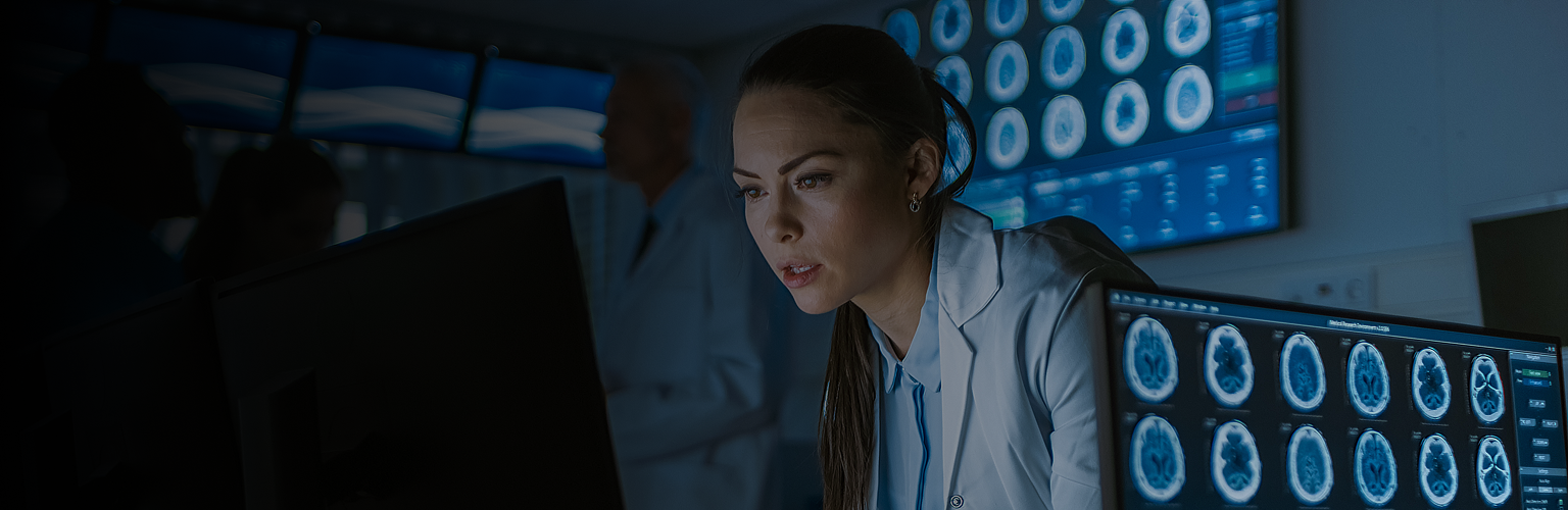 Professional woman looking at screens.