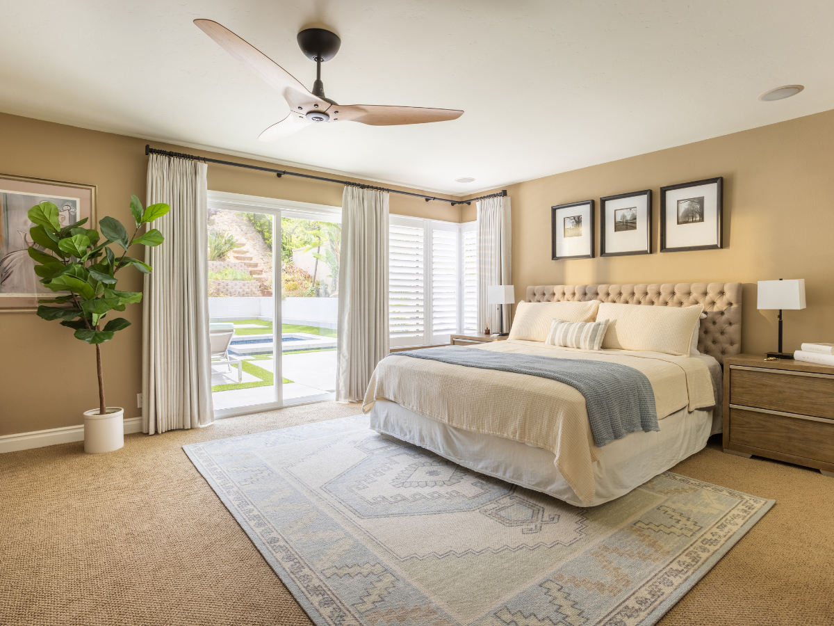 Drapery and shutters in a primary bedroom.