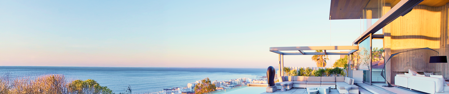 A beautifully designed infinity pool overlooking a calm body of water.