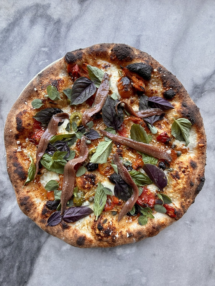 A naturally leavened cherry tomato and anchovy pizza, currently on Folk's menu in East Nashville. 
