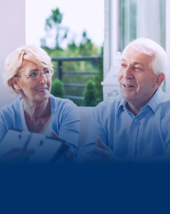 An older couple sitting on a couch, talking to advisor who is out of frame.