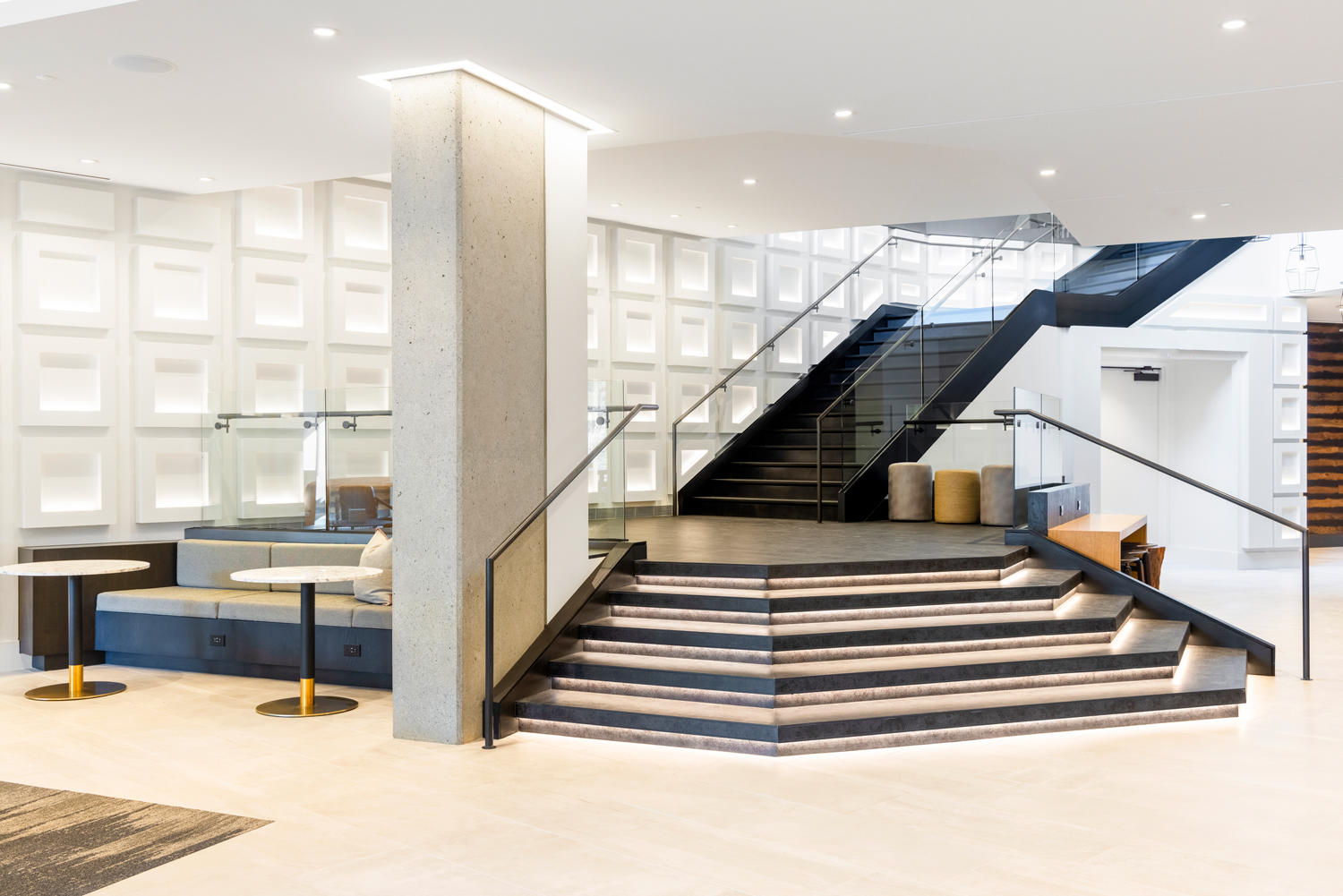 Richly illuminated lobby staircase.