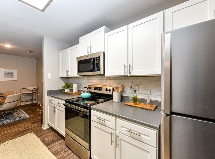 Fully Equipped Gourmet Kitchen and Pantry, with Breakfast Bar and Custom Backsplash at Lake Cameron Apartment Homes