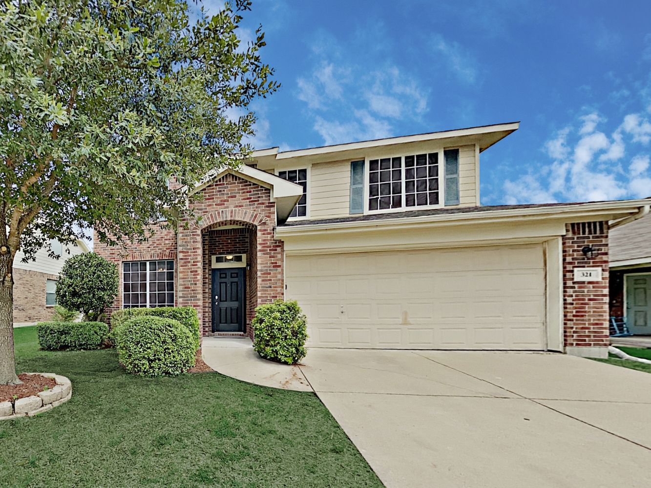 Charming home with covered porch and two-car garage at Invitation Homes Dallas.