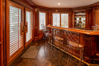 You can never go wrong with stained wooden shutters. They elevate the classic charm of this bar, while complementing the rest of the wood elements. Shutters’ versatility in light control ensures a lovely ambiance for both casual gatherings and intimate evenings!