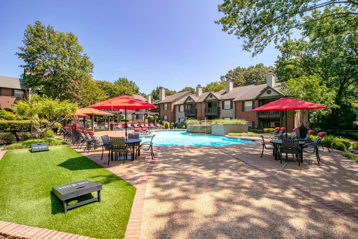 Inviting Swimming Pool with Fountain and Sundeck with Lounge Chairs and Tables for Relaxing at The Edge of Germantown Apartments Home