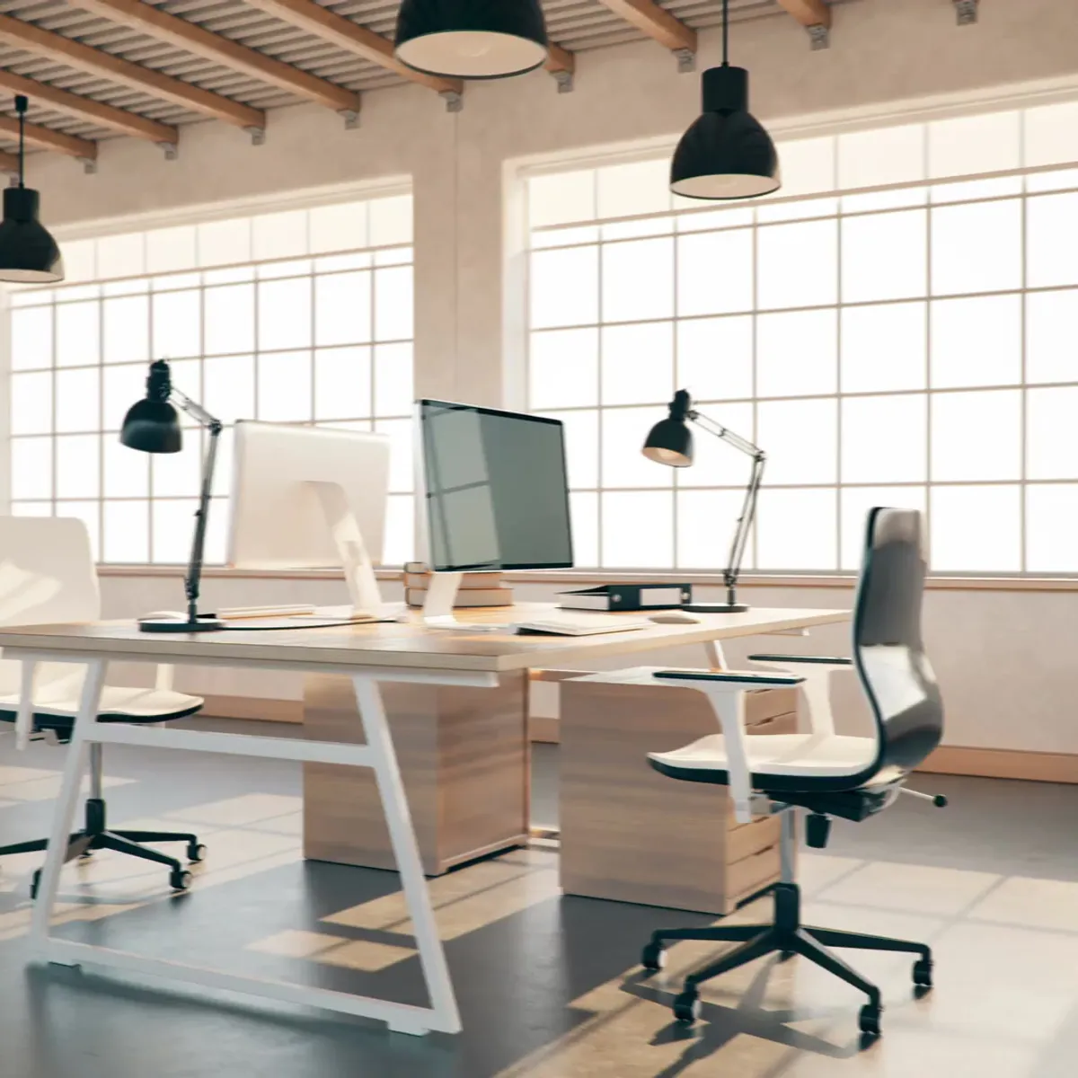 A well-lit modern office space with wooden desks, computers, and ergonomic chairs, illuminated by large windows and hanging pendant lamps.