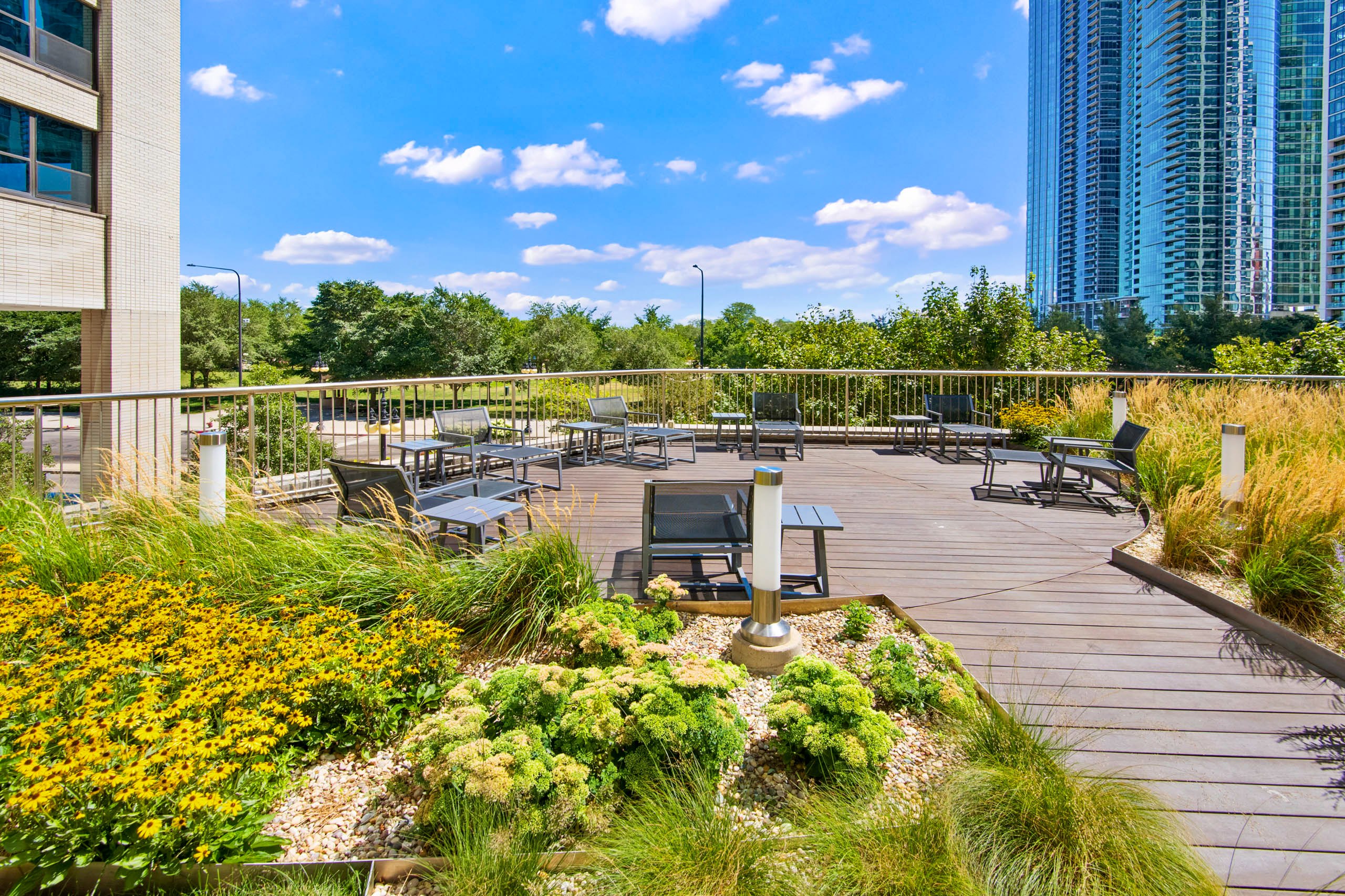 Rooftop deck with seating and green landscaping 