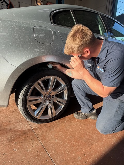 Technician inspecting tire condition and tread at Walker Tire Point S, 4221 S. 48th Street in Lincoln, Nebraska