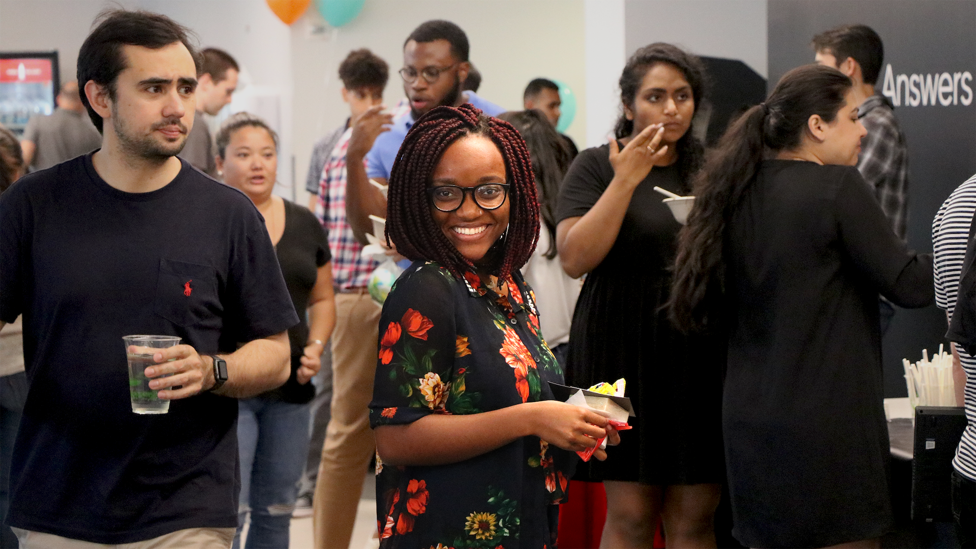 A crowd of Yexters at an ERG event. One person is looking at the camera and smiling.