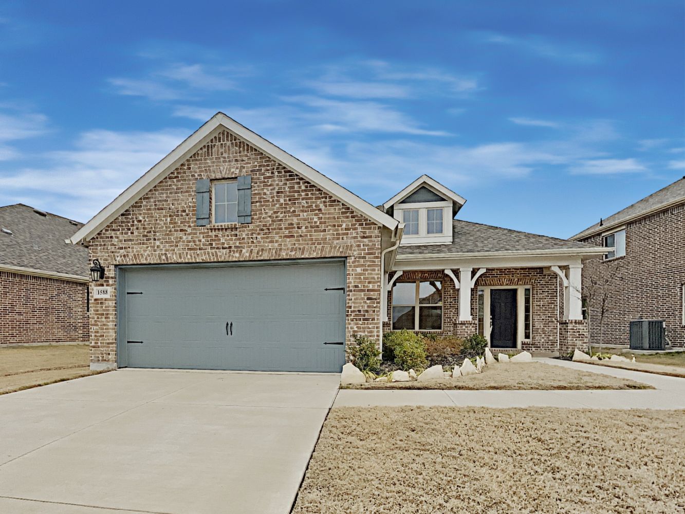 Inviting home with a covered porch and two-car garage at Invitation Homes Dallas.
