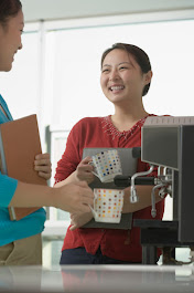 Employees enjoy coffee machine in break room