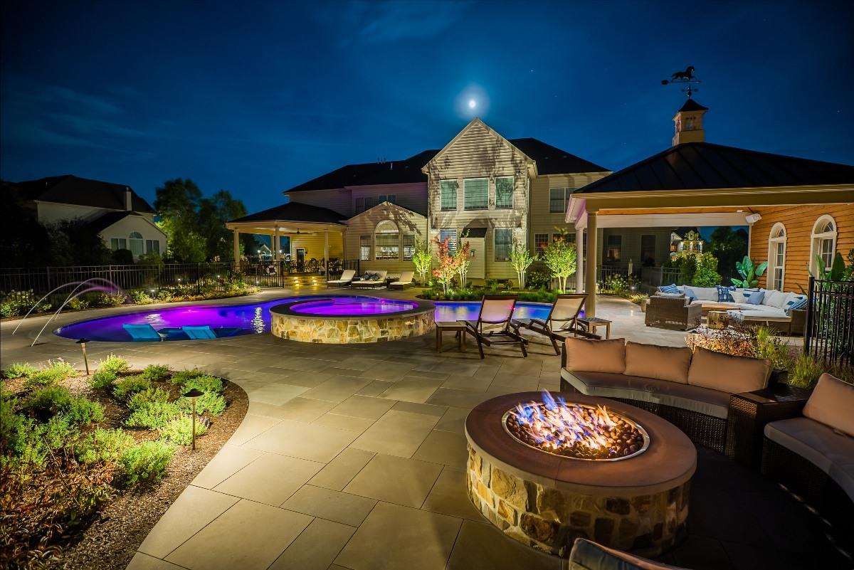 Plantings, lighting, limestone pool deck, fencing, terrace, steps, veneer, pool, and fire feature designed, built, and maintained by Garden Artisans. Pool and spa designed, built, and maintained by Liquidscapes. 609-273-6519 609-371-0099 609-647-0666 www.gardenartisansllc.com