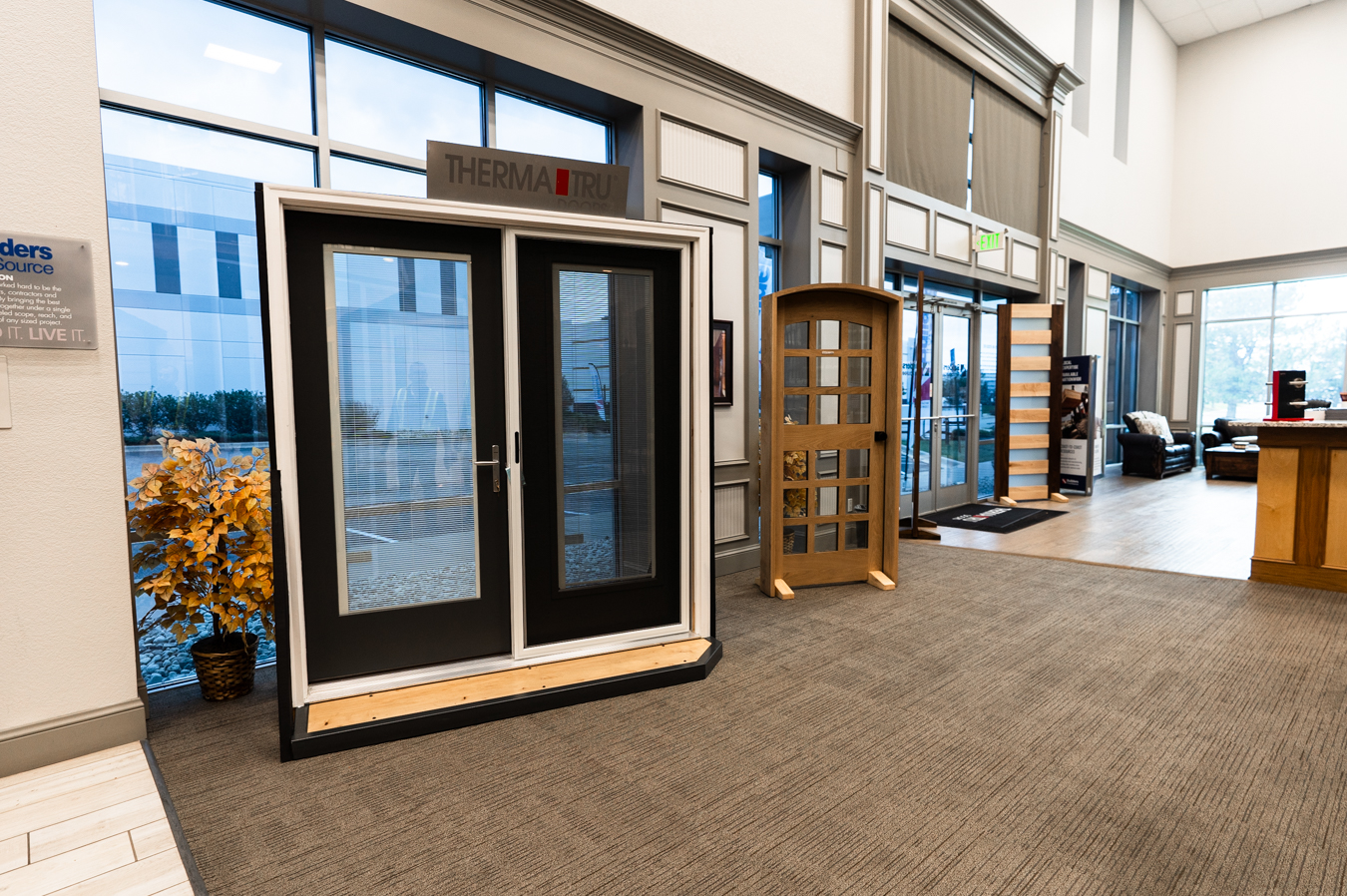 Builders FirstSource showroom with Therma-Tru doors display, modern interior, and natural light from large windows.