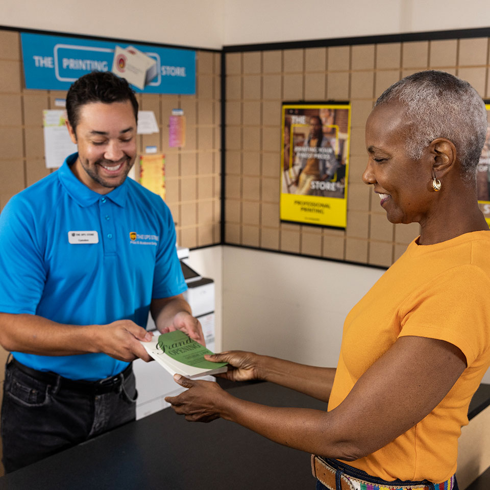 UPS Store Associate assisting with copies