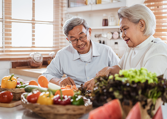 A married couple sharing a moment together in the kitchen.