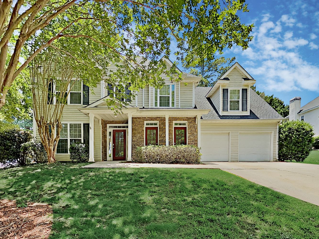 Charming home with a two-car garage and covered porch at Invitation Homes Atlanta.