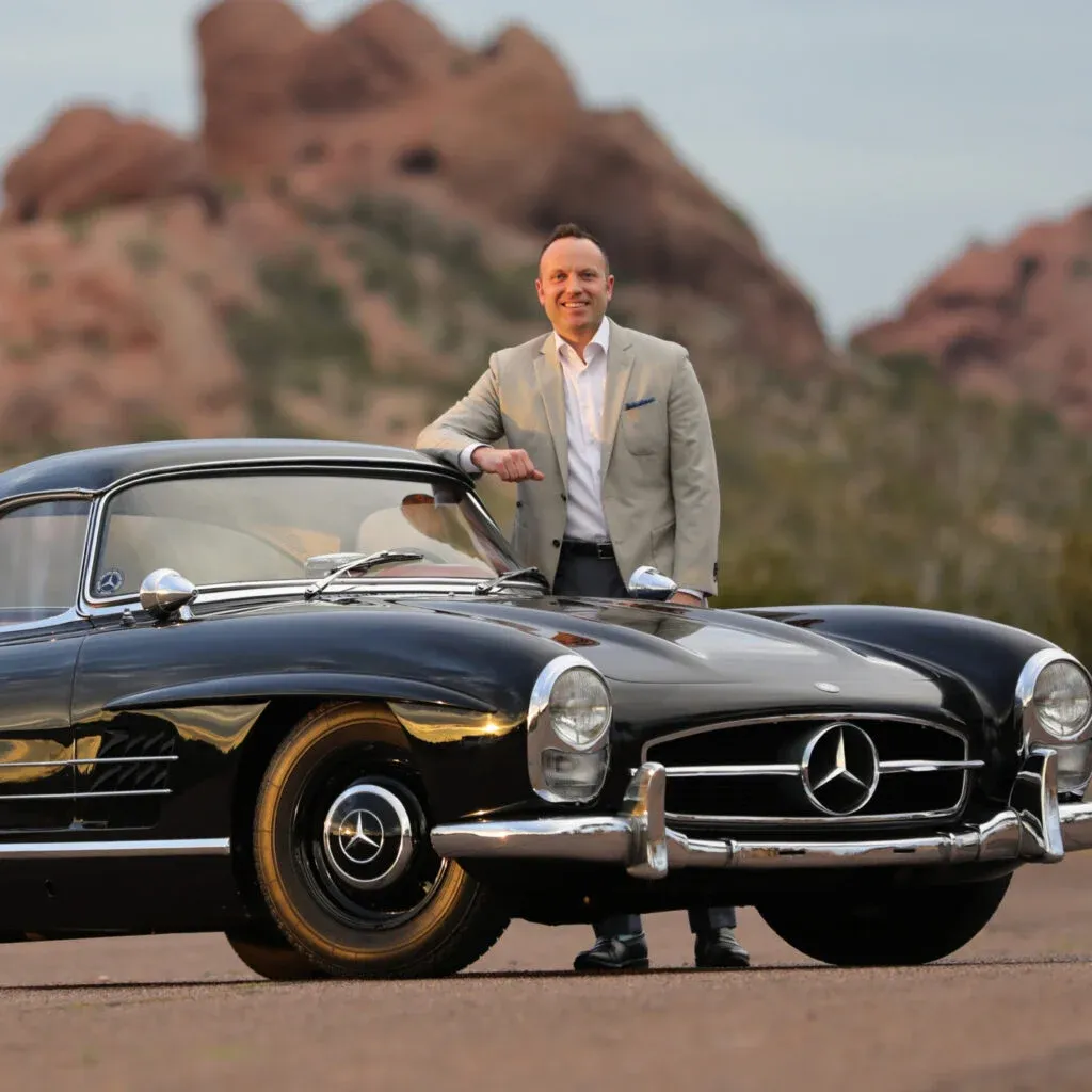John Kruse, CEO of Kruse Auctions, presenting a classic collector car during a live auction in Auburn, Indiana.