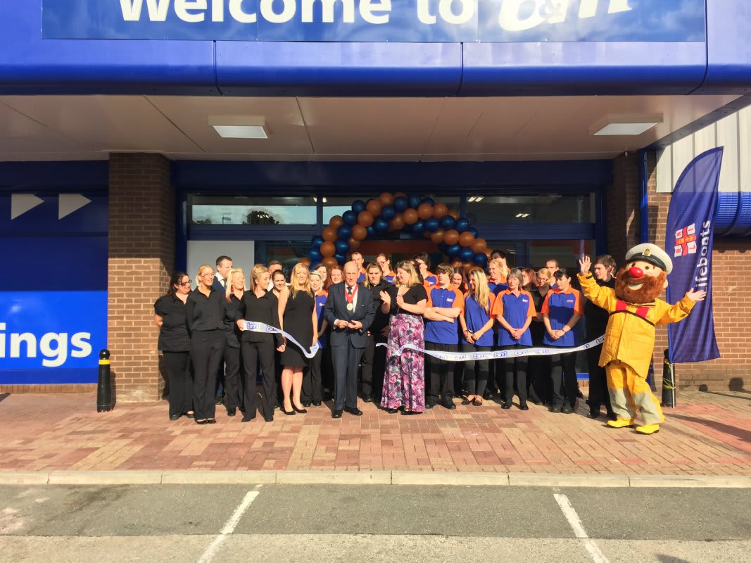 Store staff are joined by representatives from RNLI who cut the ribbon at the B&M Poole store opening
