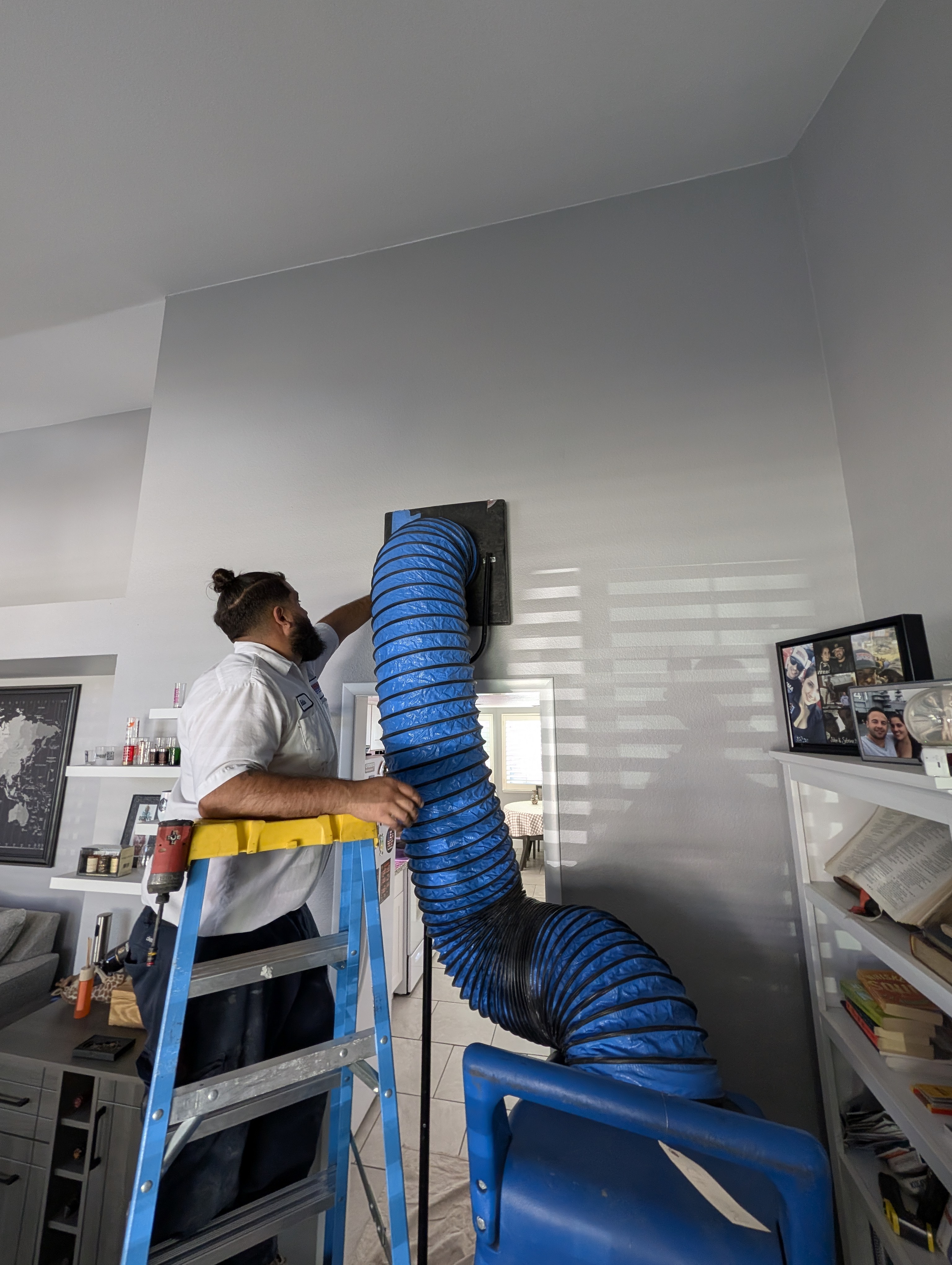 Technician doing a professional duct work cleaning on clients house 