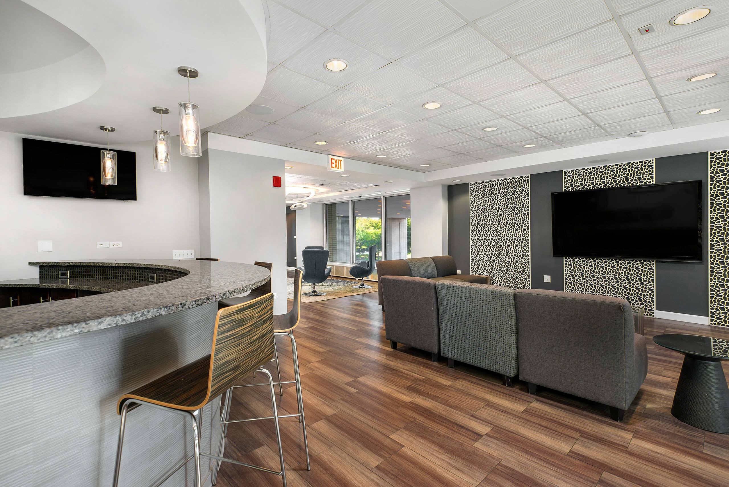 Modern clubroom with bar seating and lounge area 