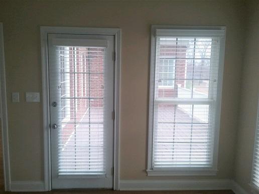 Unite your space by giving the same treatment to the window and doors, like with these Faux Wood Bli Budget Blinds of Knoxville & Maryville Knoxville (865)588-3377