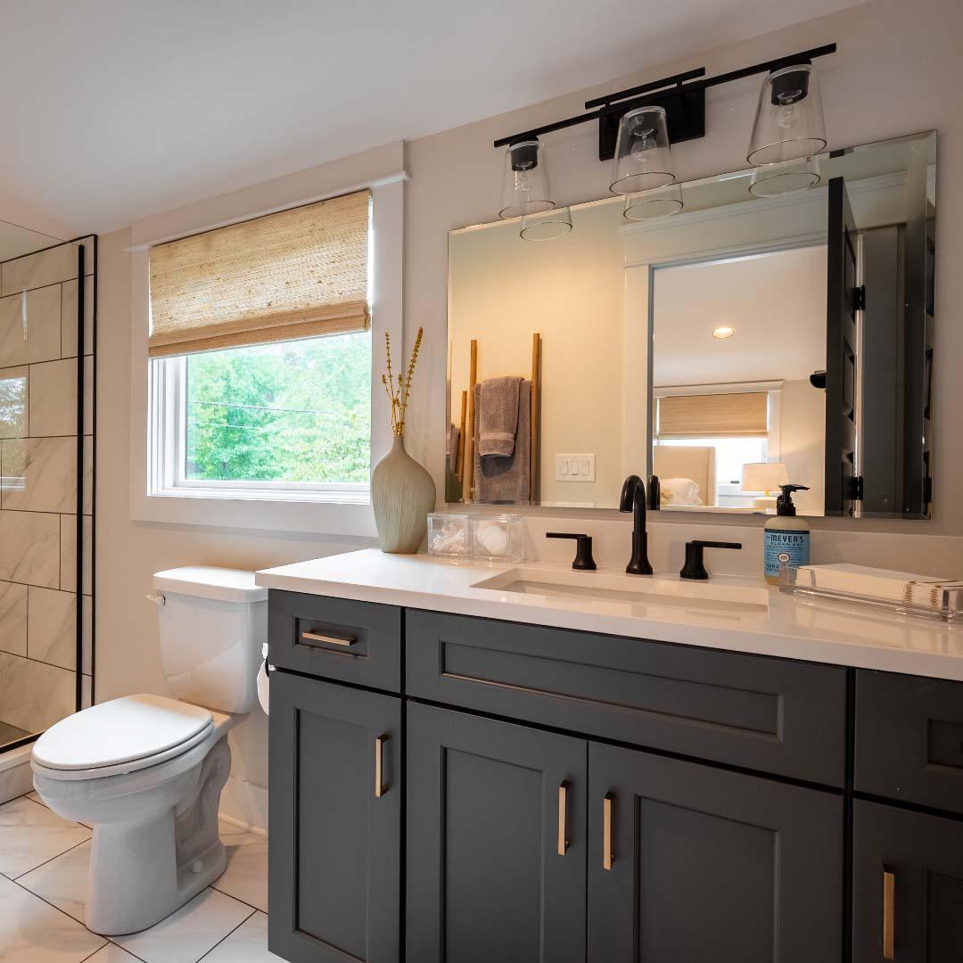 This bathroom demonstrates how window treatments can be used to accentuate other elements in your design. Here, these woven wood shades match the other all-natural materials throughout this bathroom.