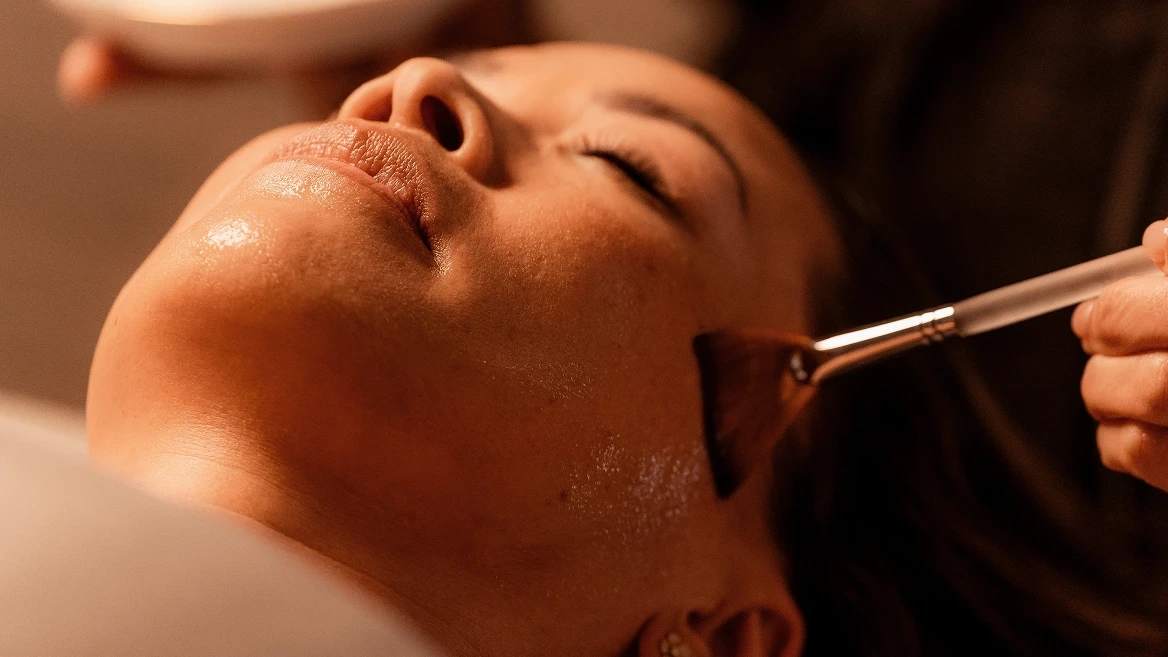 Professional facial treatment with serum application for Club members at luxury spa
