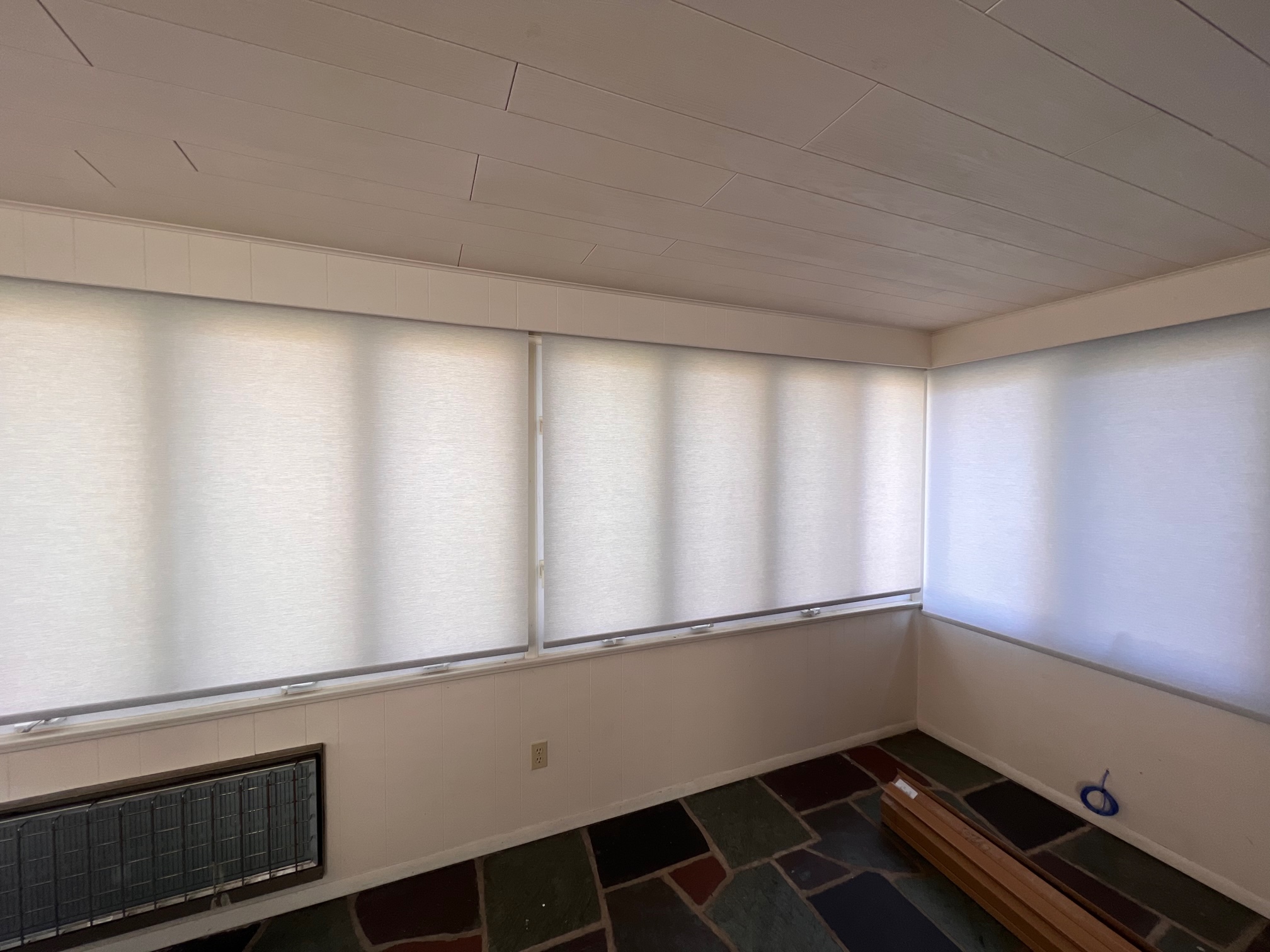 Beautiful motorized roller shades for a sunroom allow custom light filtration with the touch of a button!