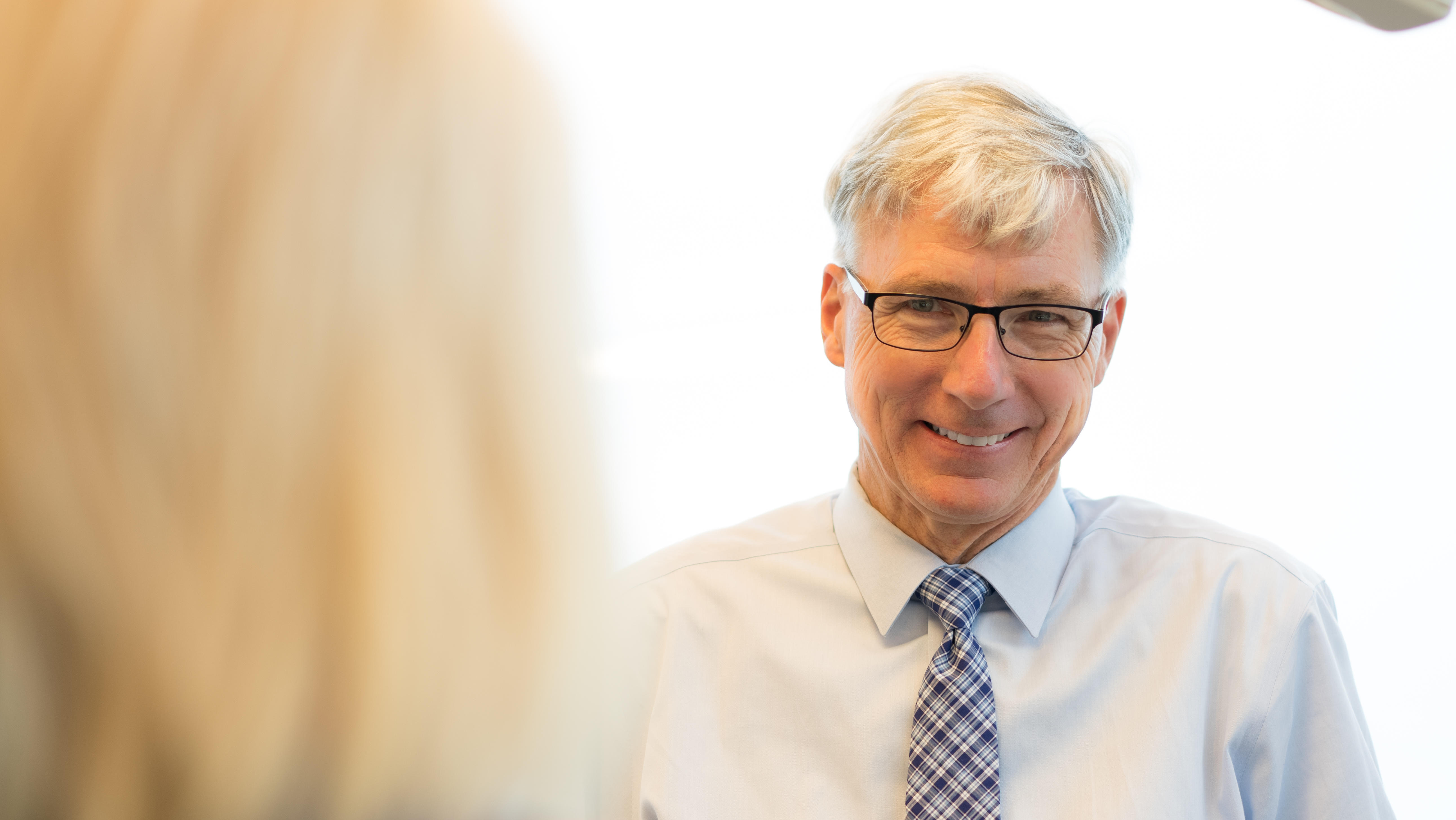 Dr. Brendan Cooney smiling at Patient in Troy, Ny orthodontic office.