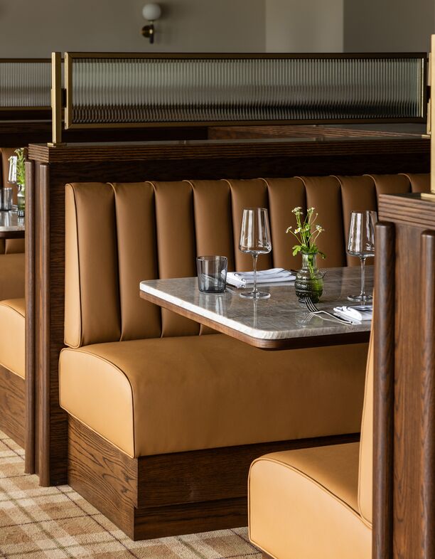 Tucked into rich caramel leather, every seat at Matchplay feels like the best seat in the house.