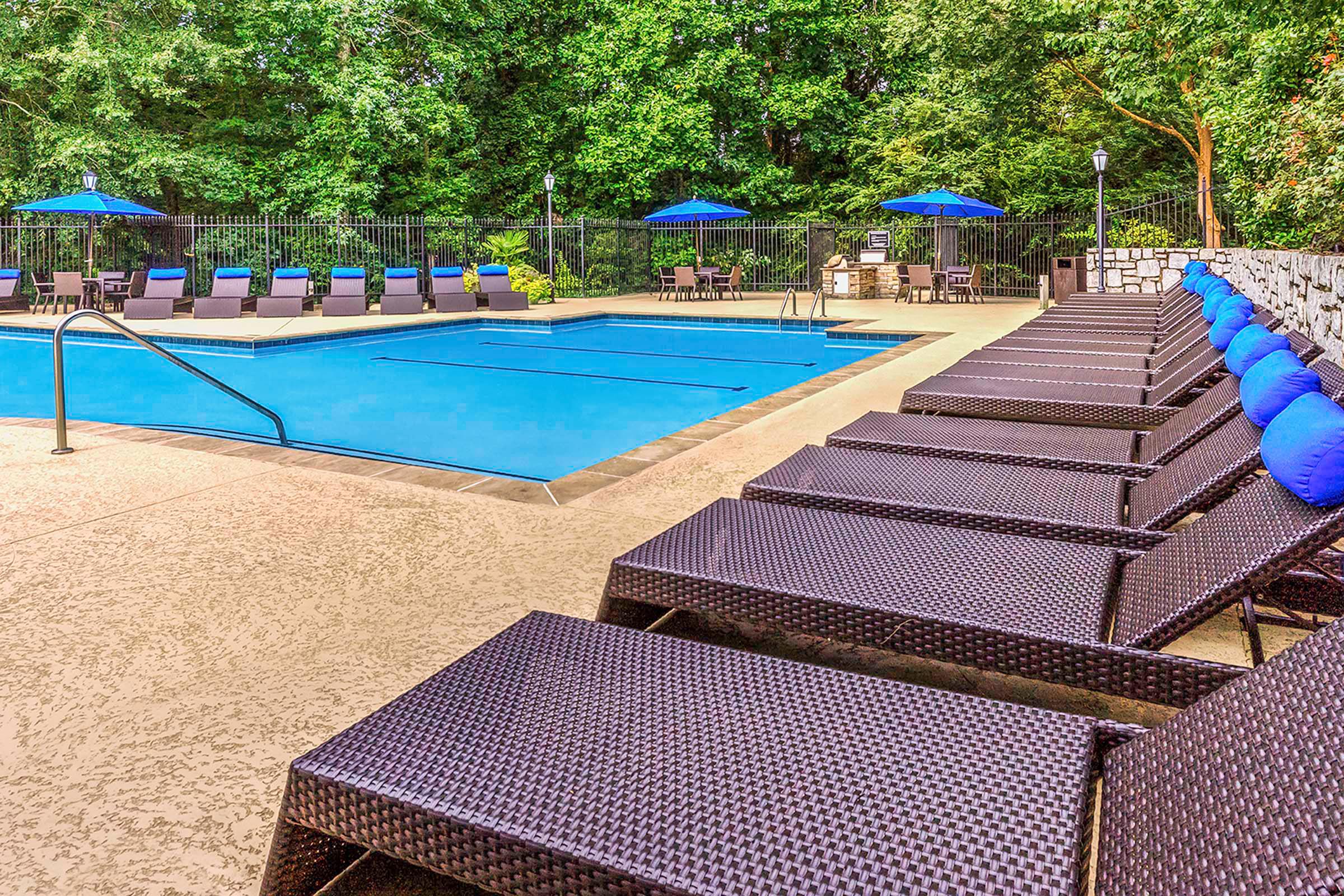 Resort style pool with sundeck for lounging and umbrellas Camden Deerfield Apartments Alpharetta (770)872-6592