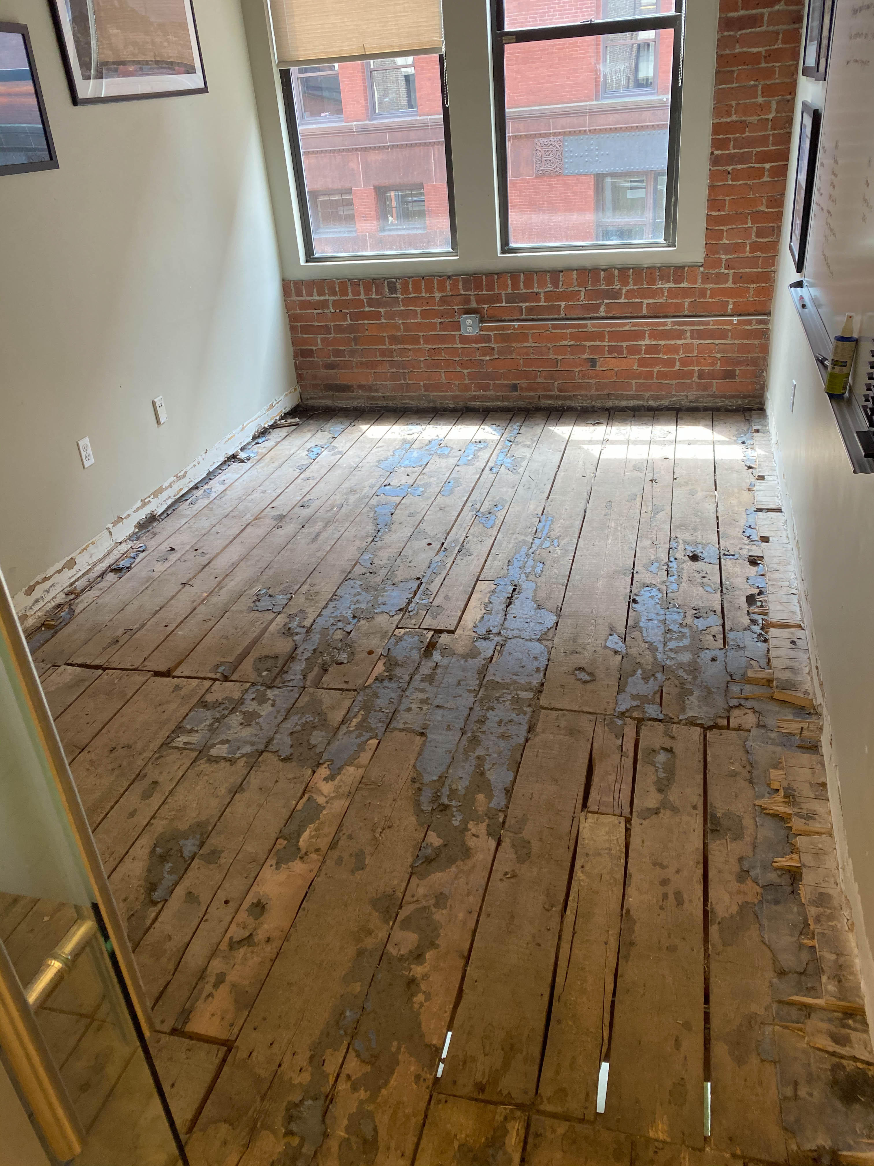 Removed flooring exposing subfloor in a commercial property.