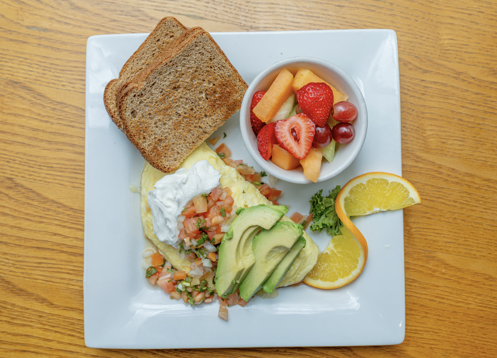 A variety of egg scrambles or omelets, served with either hash browns or fresh fruit, with your choice of toast or homemade biscuit. Substitutions for egg white or no-cholesterol eggs available.
