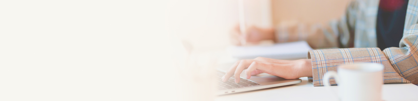 Hands typing on a laptop.