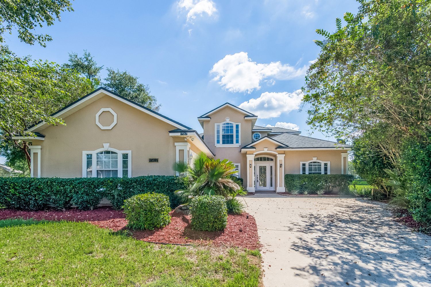 Beautiful home with landscaping and long driveway at Invitation Homes Jacksonville.