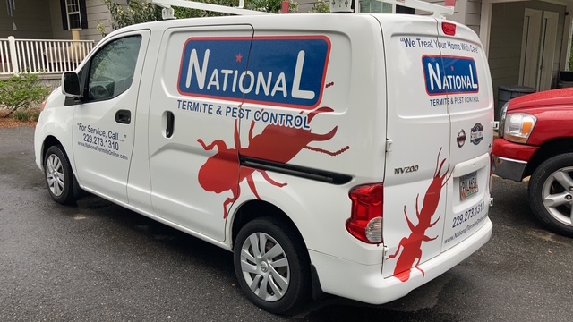 National Termite & Pest Control service vehicle parked outside residential property