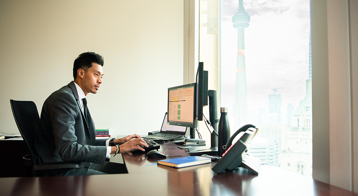 Adrian Bacchus, Senior Financial Planner, working at his desk.