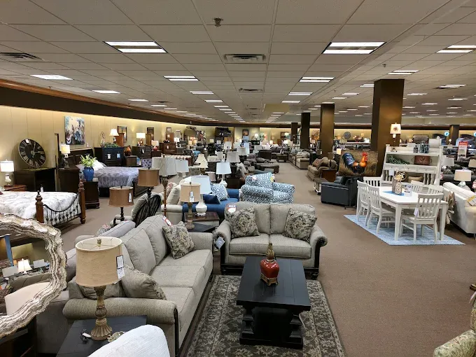 Large Neill&rsquo;s Homestore furniture showroom with sofas, recliners, dining tables, bedroom sets, lamps, rugs, and home accents displayed across the sales floor.