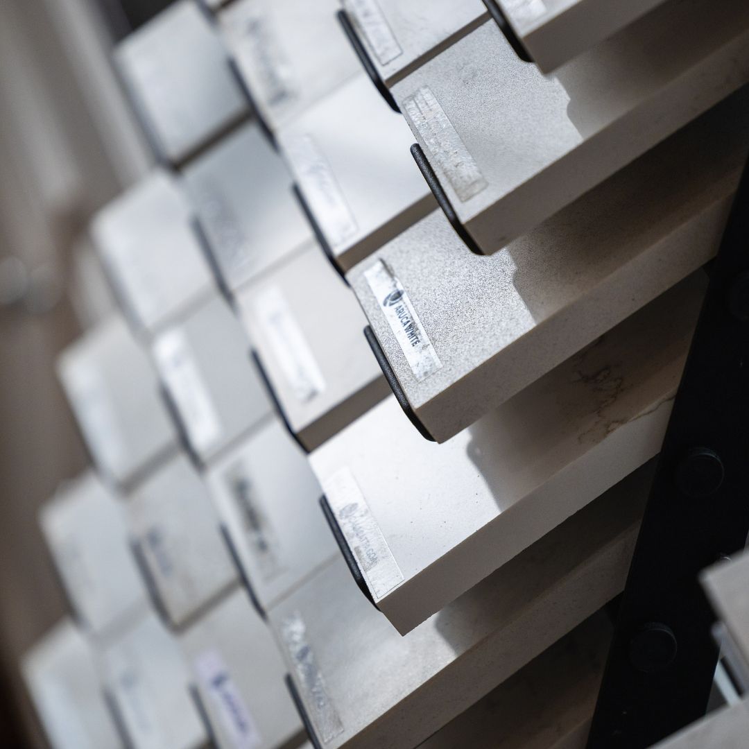 Close-up view of quartz countertop material samples with labeled finishes
