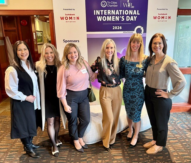 Six women posing at International Women's Day 2026 event presented by Women Initiative