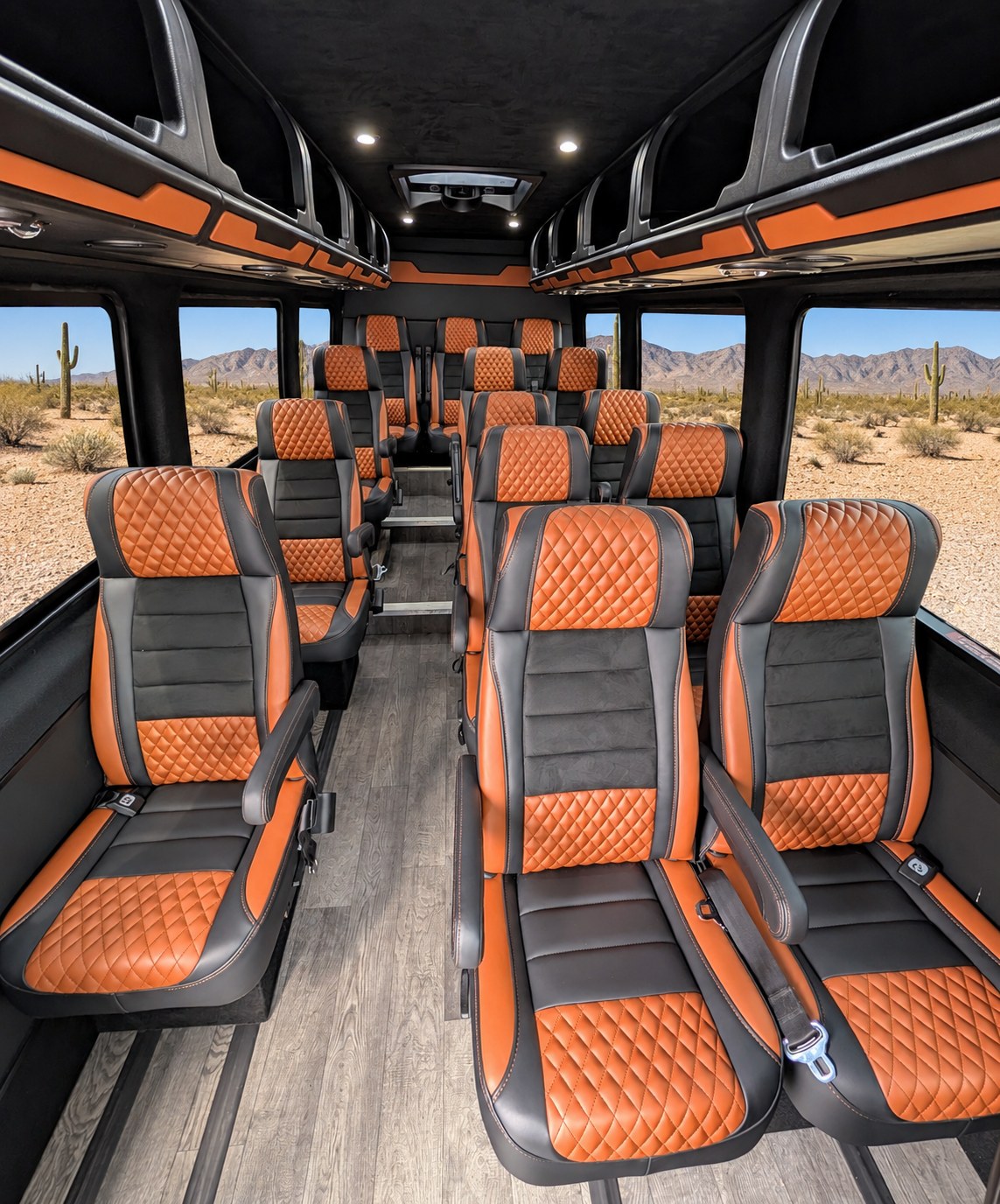 Luxury shuttle interior featuring orange-accented passenger seating.
