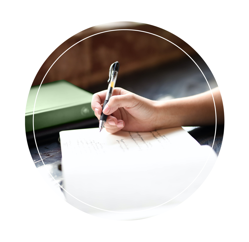 An individual writing in a journal.